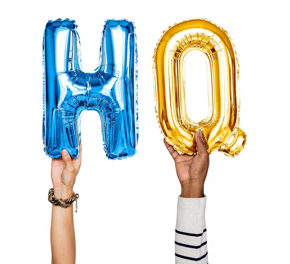 Hands holding balloons spelling HQ