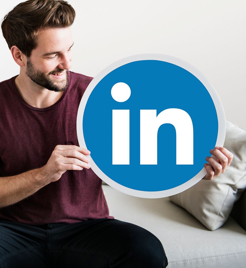Person holding a Linkedin icon