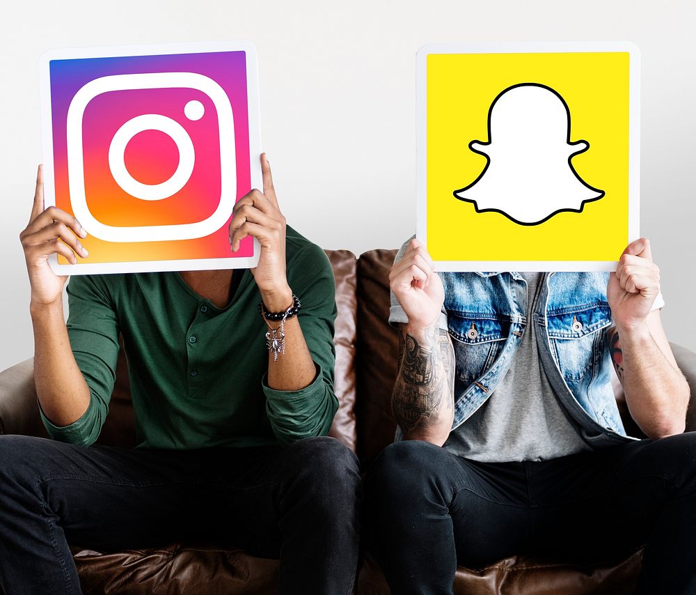 Men holding social media icons