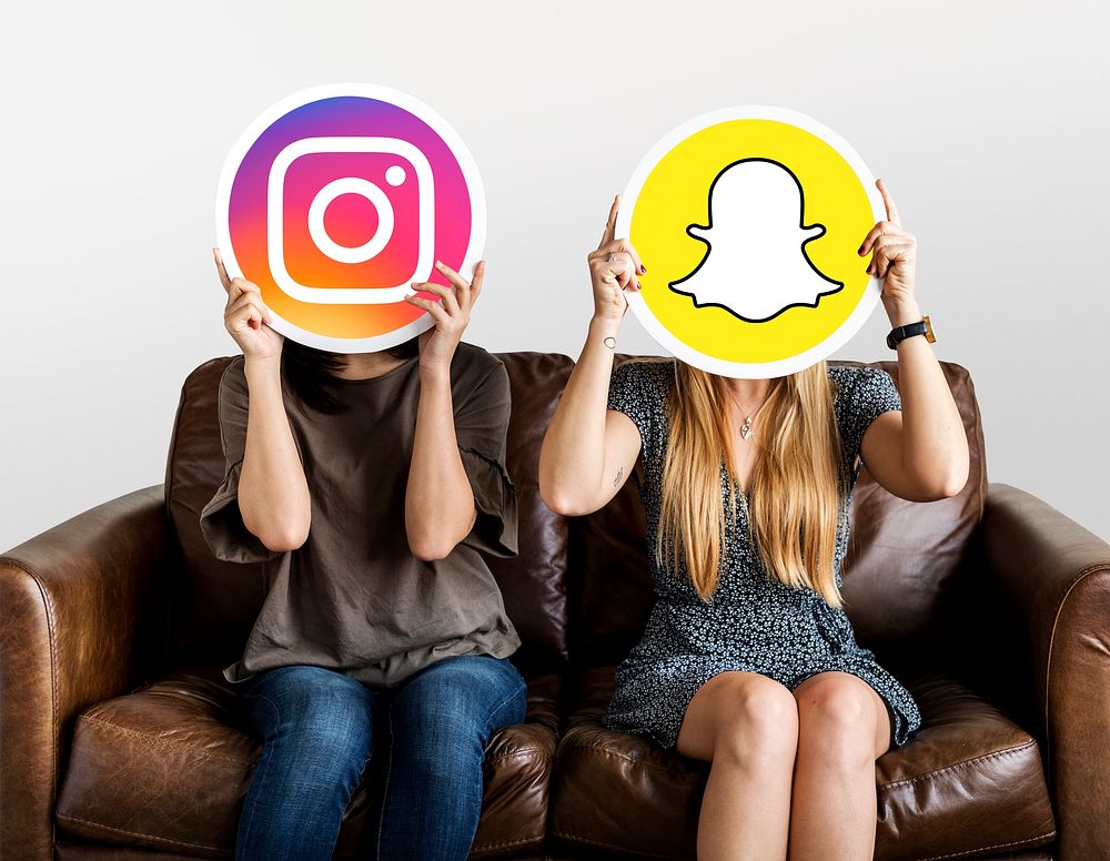 Women holding social media icons