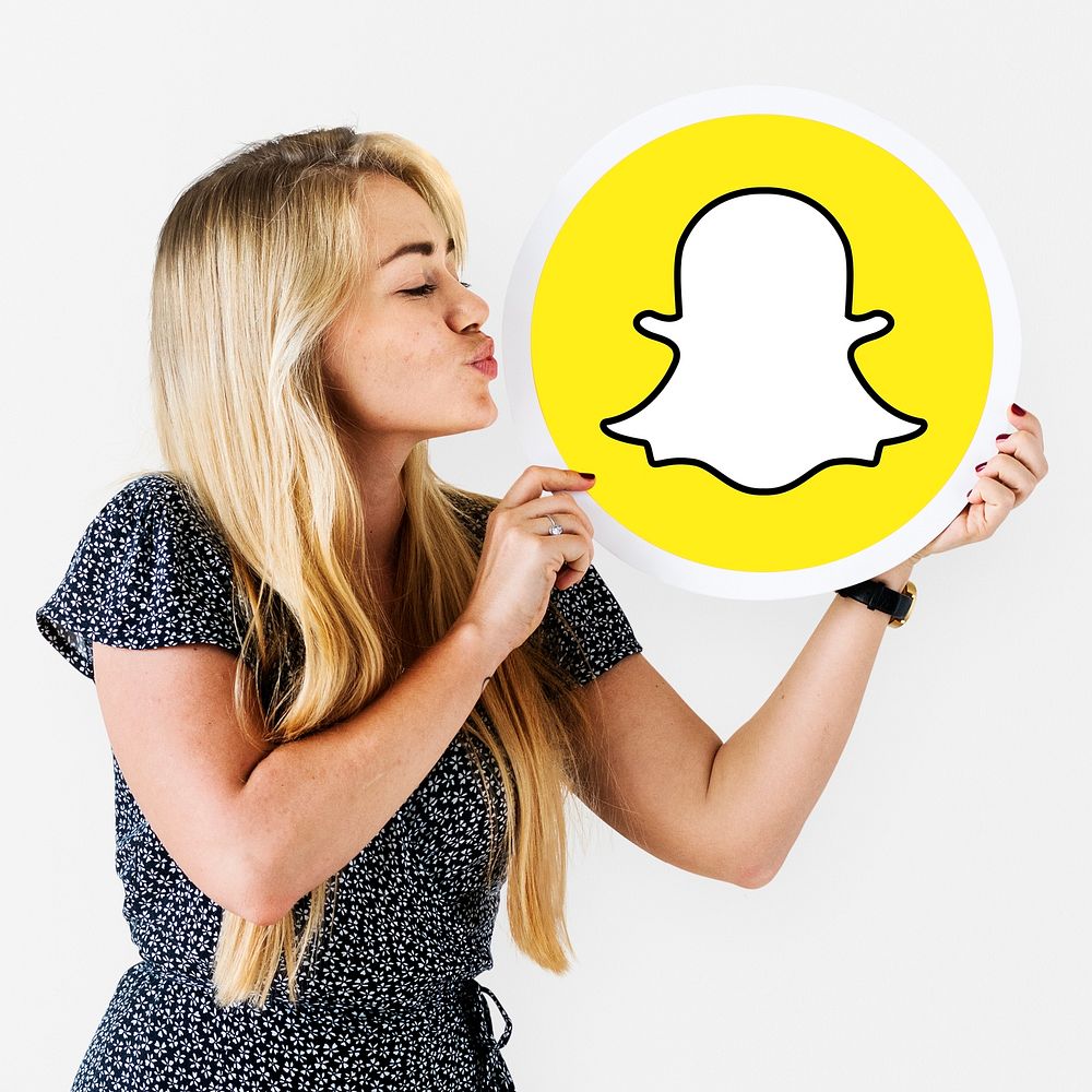 Woman blowing a kiss to a Snapchat icon