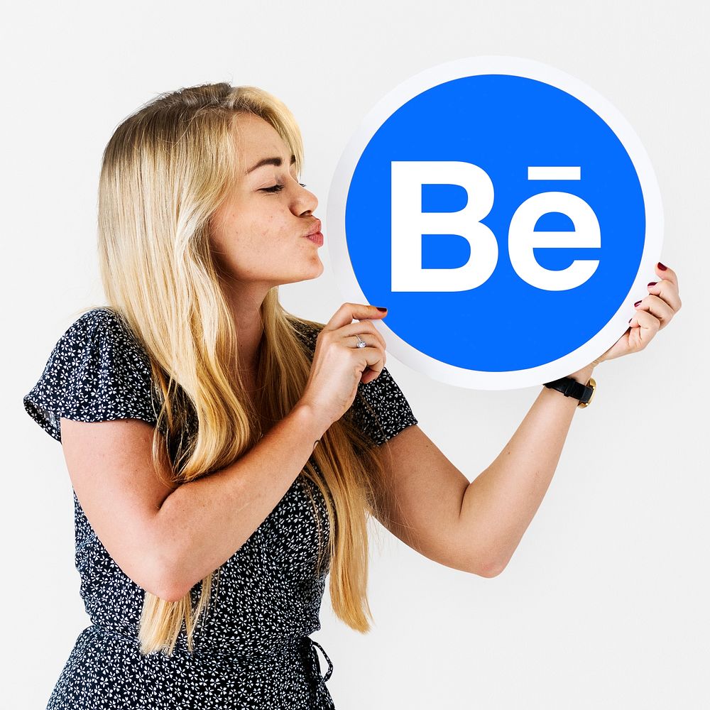 Woman holding a logo of Behance