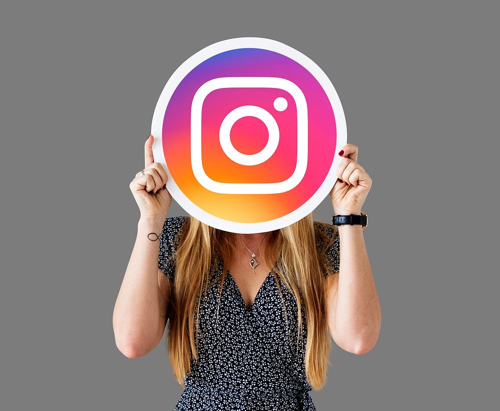 Woman showing an Instagram icon