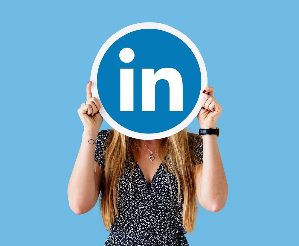 Woman holding a Linkedin icon