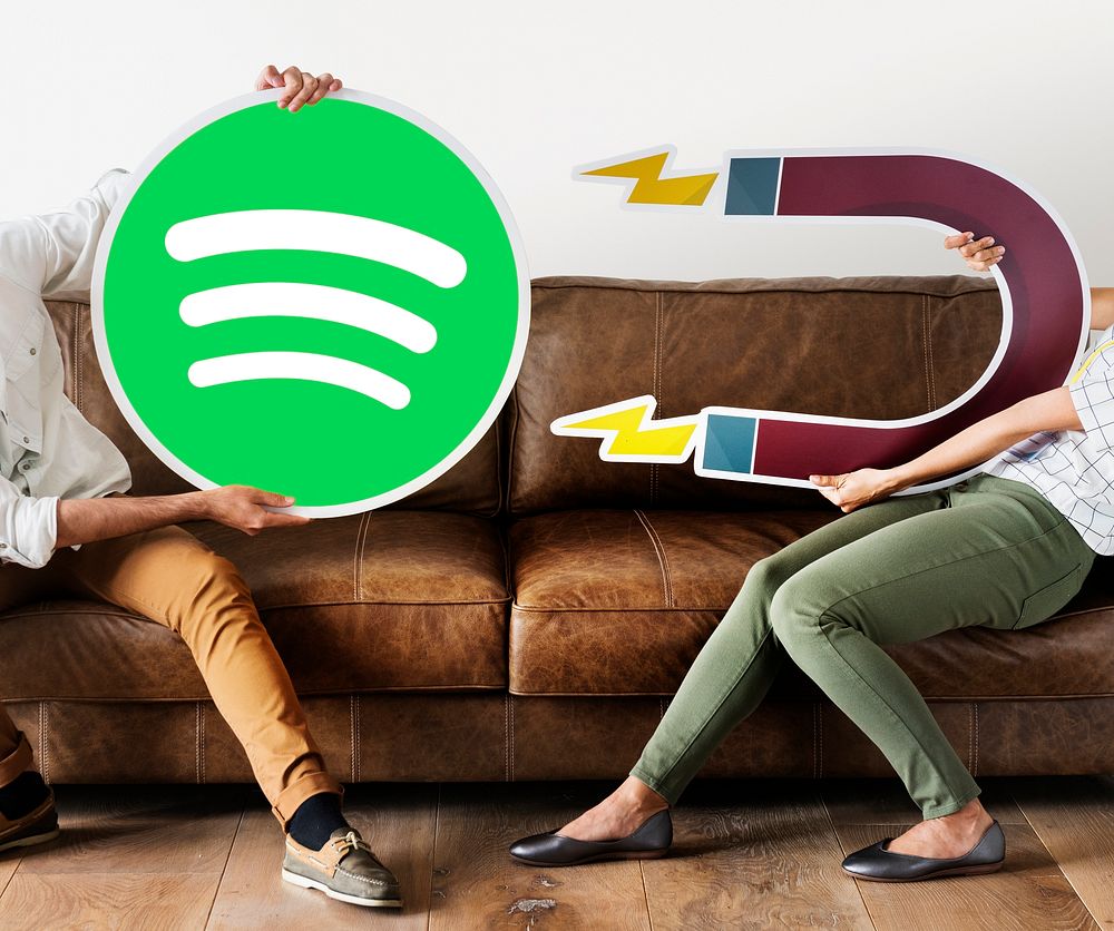 People holding a Spotify icon