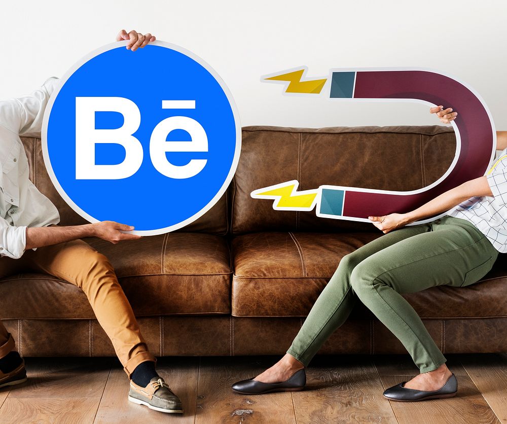 People holding a Behance icon with a magnet