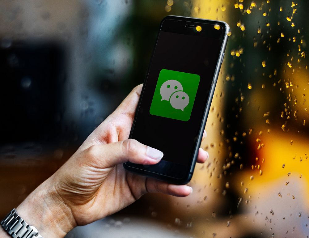 Person using WeChat application on a phone. BANGKOK, THAILAND, 1 NOV 2018.
