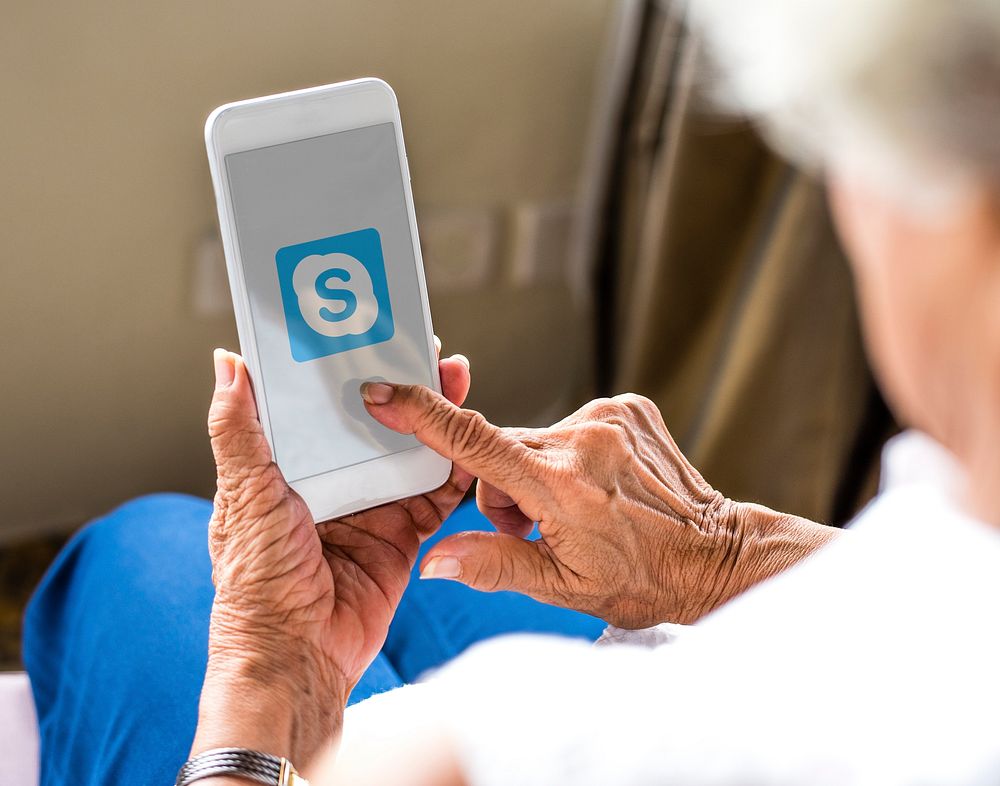 Elderly woman using Skype on a phone. BANGKOK, THAILAND, 1 NOV 2018.