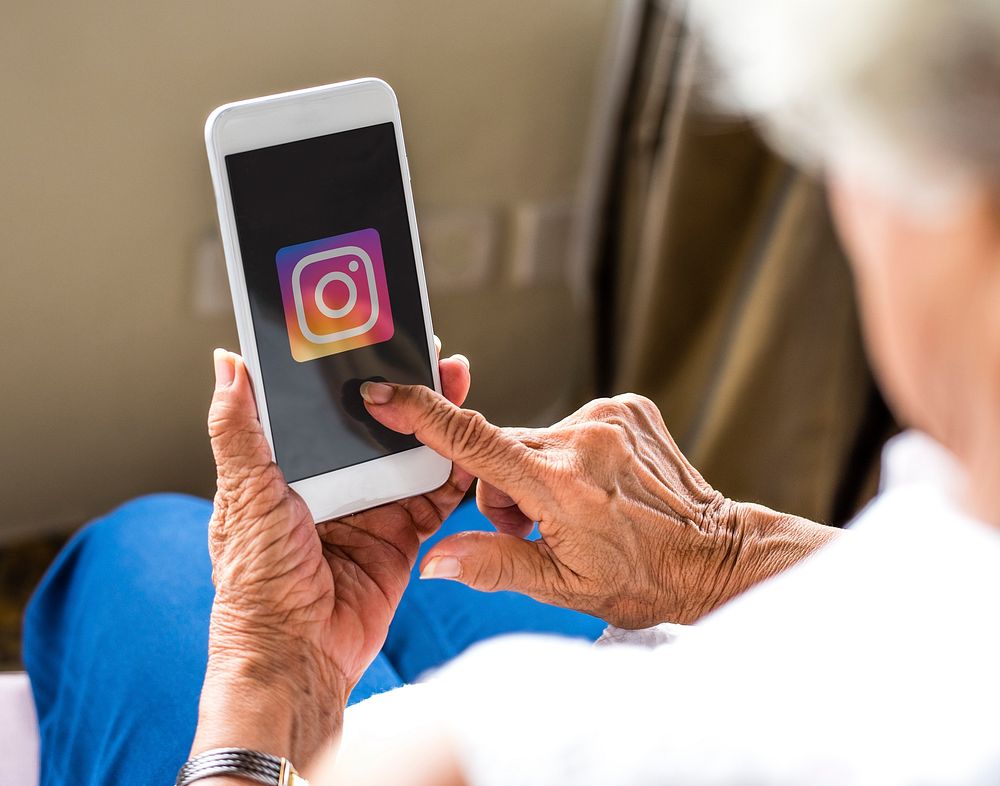 Elderly woman using Instagram application on a mobile phone. BANGKOK, THAILAND, 1 NOV 2018.