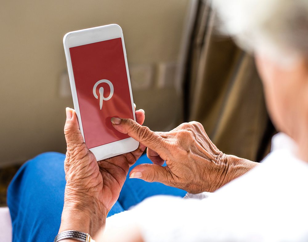 Elderly woman using Pinterest application on a mobile phone. BANGKOK, THAILAND, 1 NOV 2018.