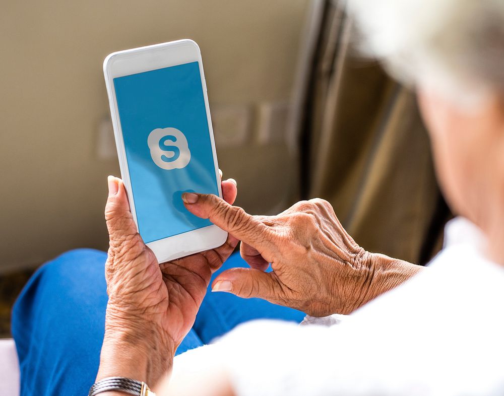 Elderly woman using Skype on a phone. BANGKOK, THAILAND, 1 NOV 2018.