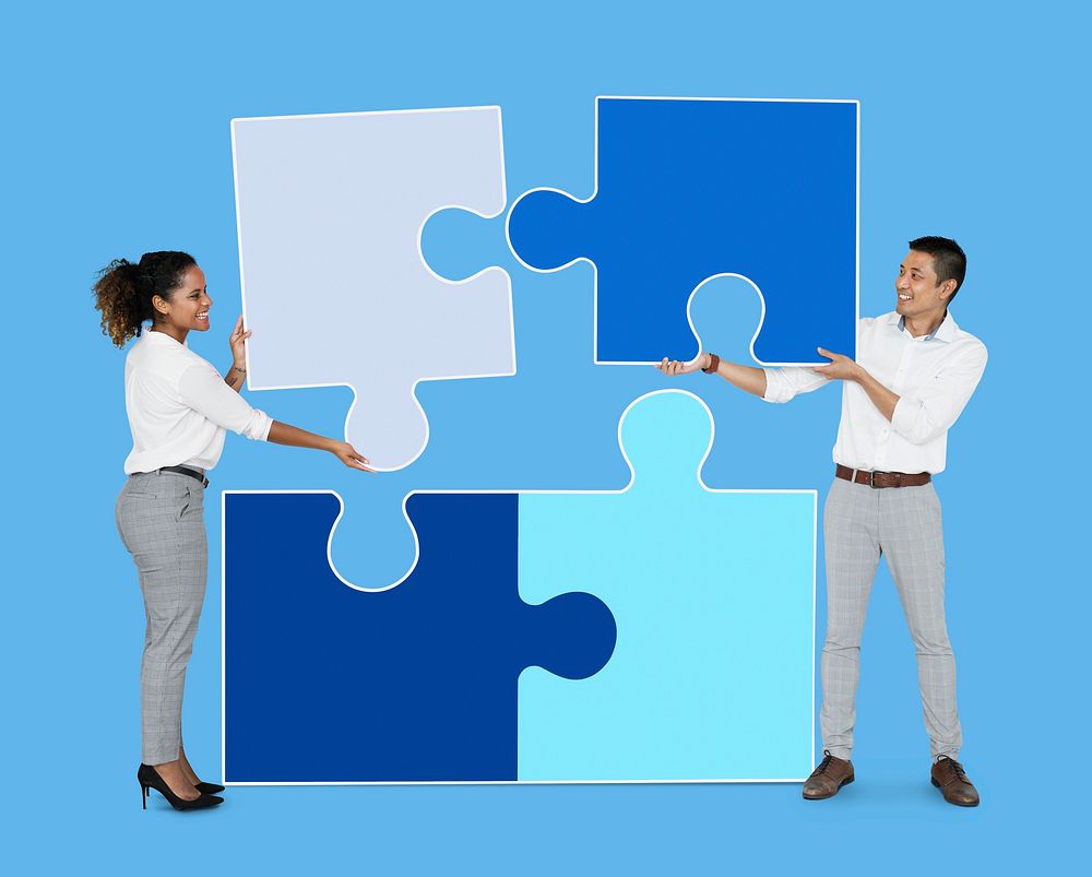 Colleagues connecting puzzle pieces