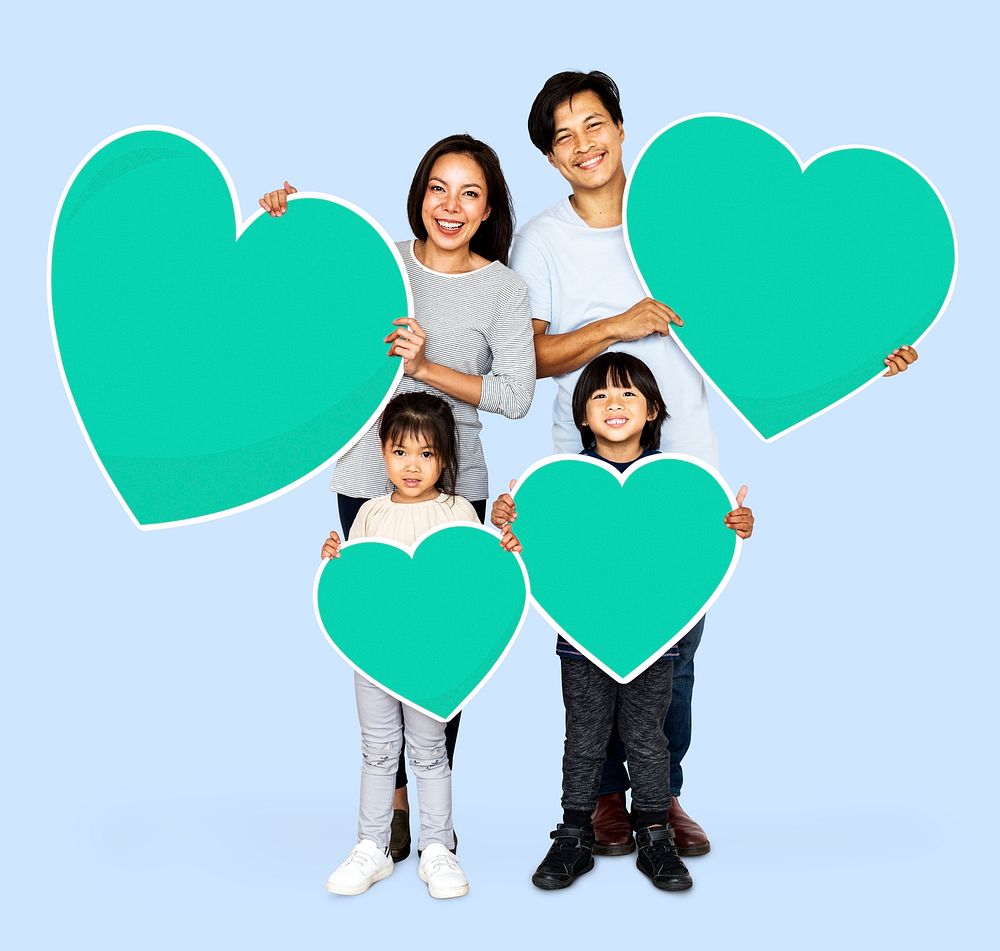 Happy family holding heart icons