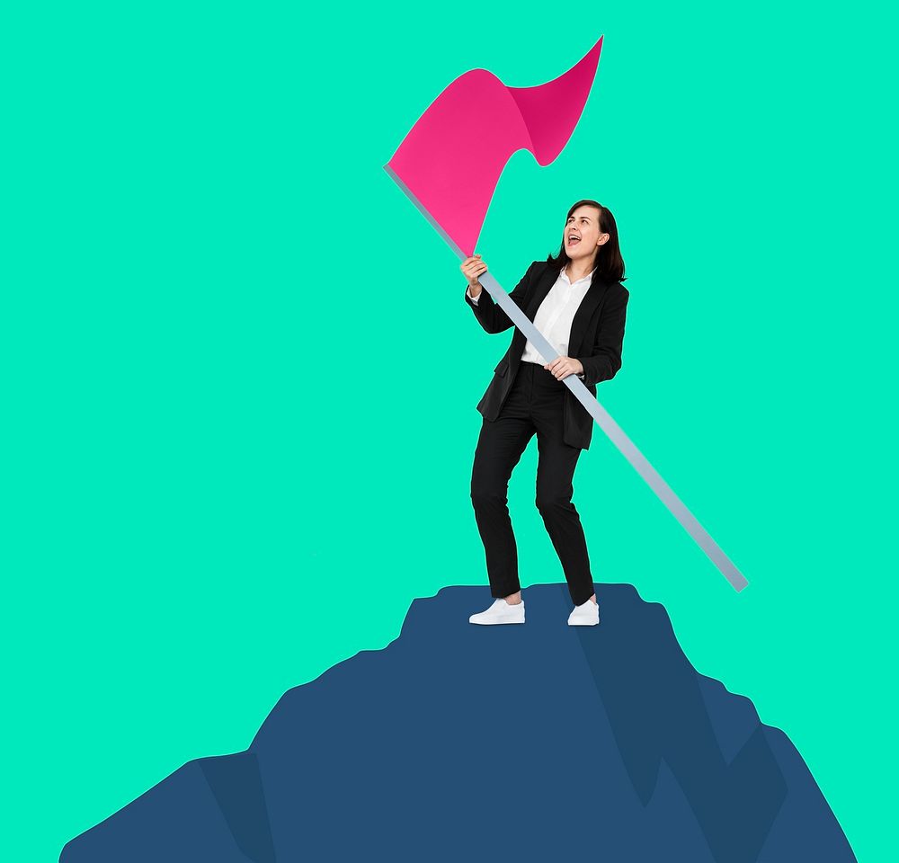 Successful woman waving a flag on top of the mountain