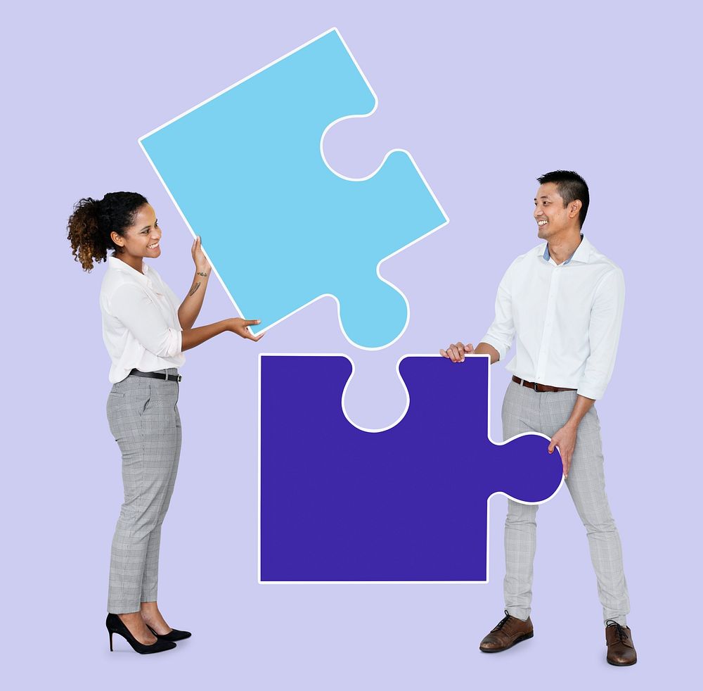 Businesspeople connecting jigsaw puzzle pieces