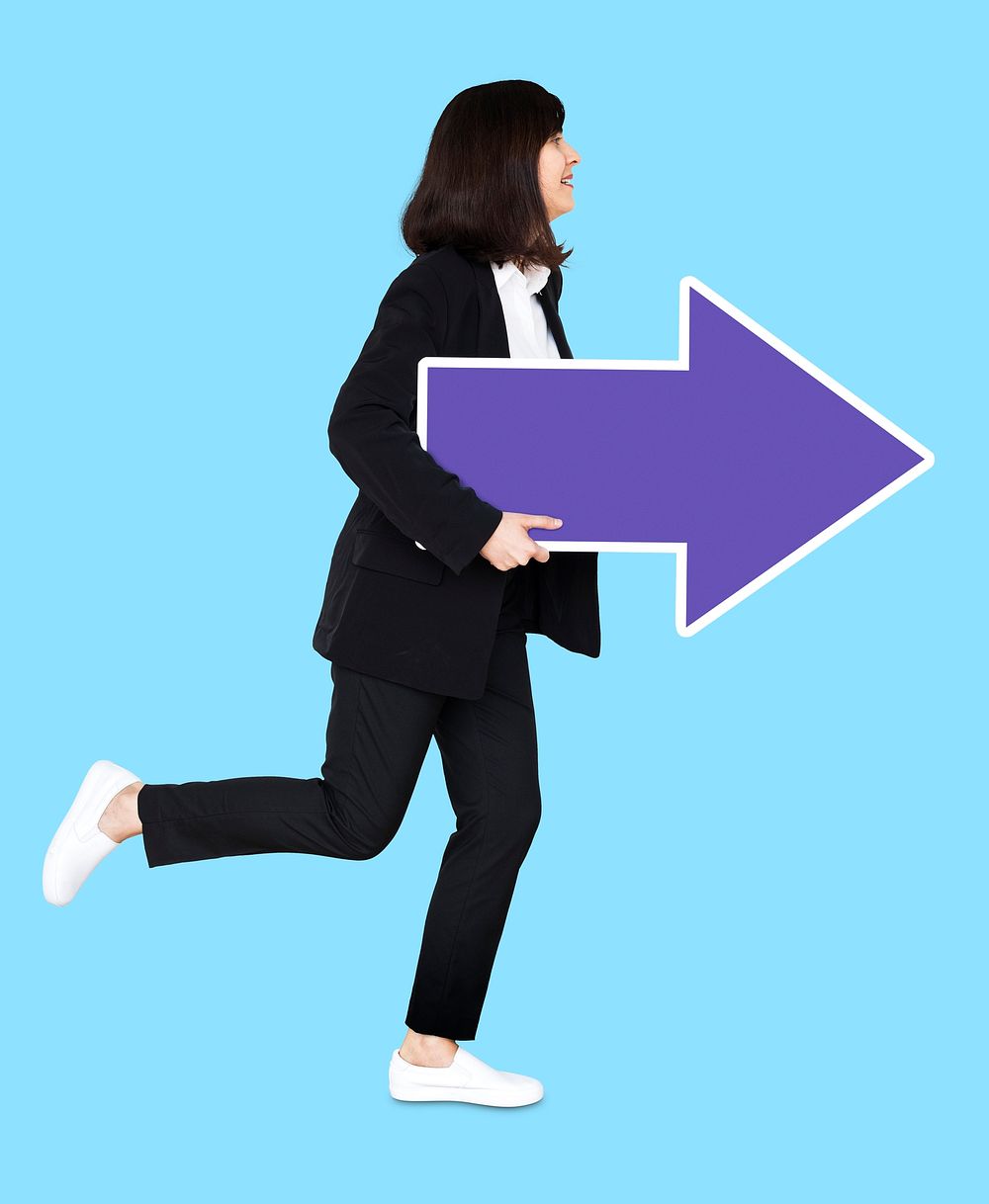 Cheerful businesswoman running with a purple arrow