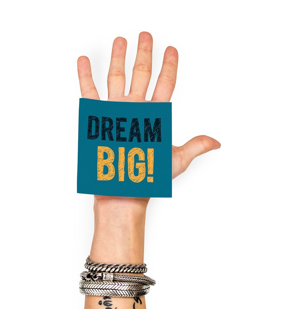 Hand showing a sticky note with Dream big
