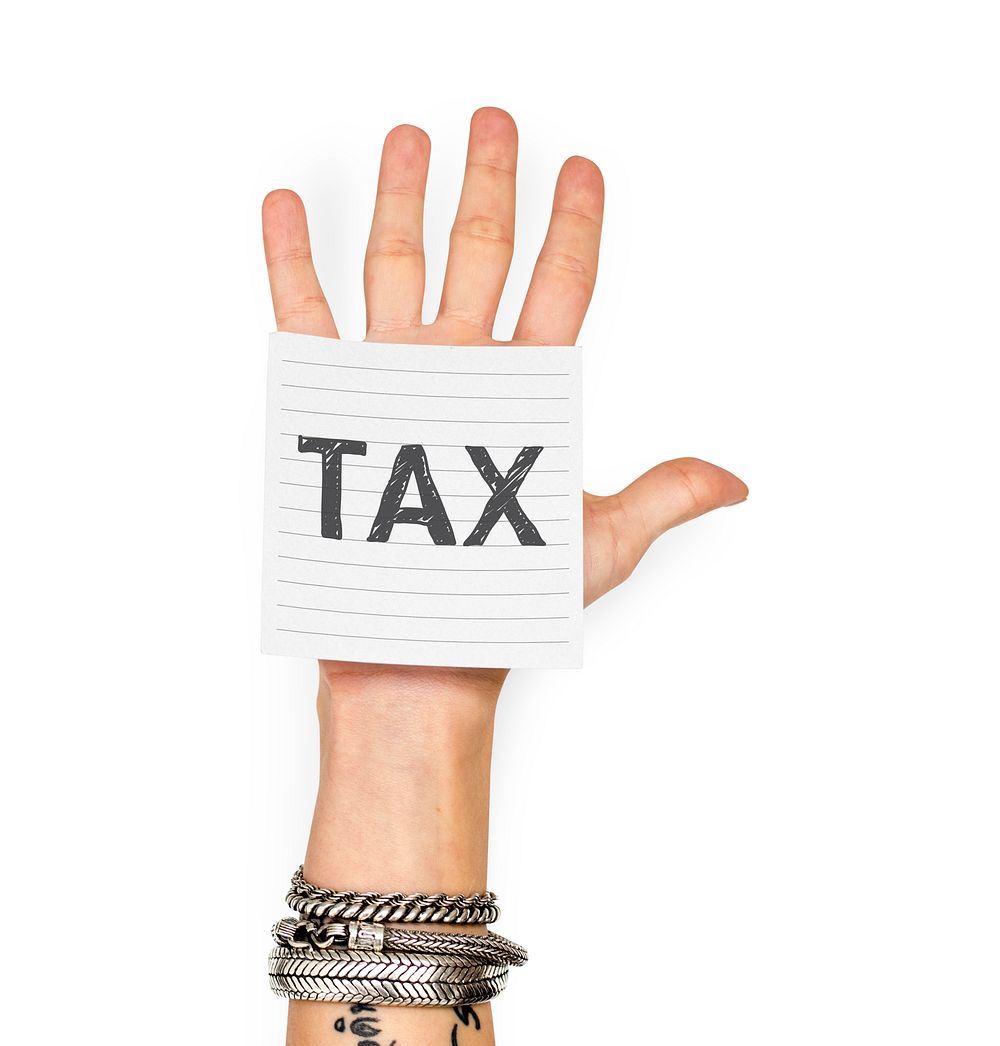 Hand showing a sticky note with Tax