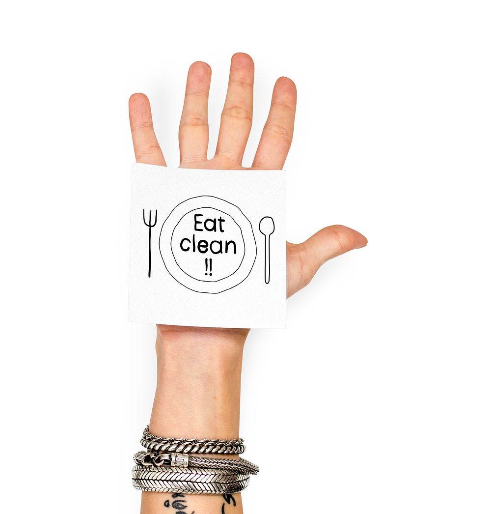 Hand showing a sticky note with Eat clean