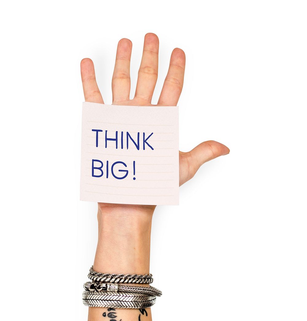 Hand showing a sticky note with Think big