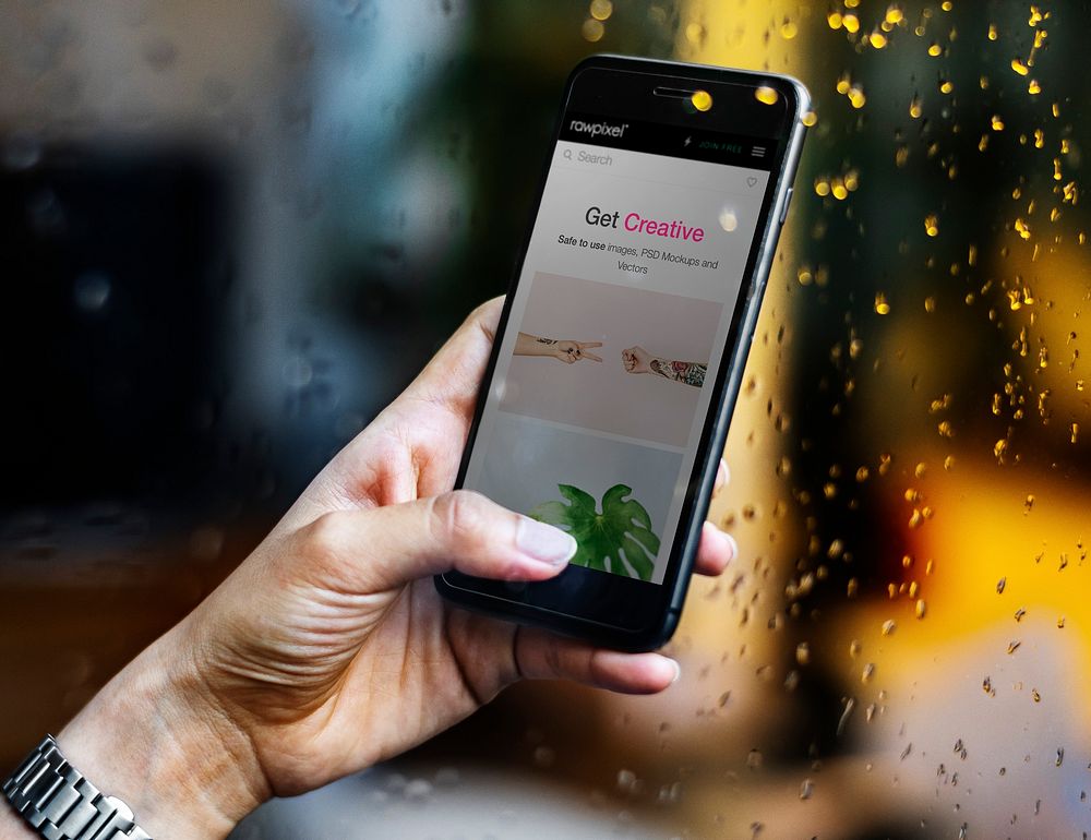 Woman holding a phone in the rain