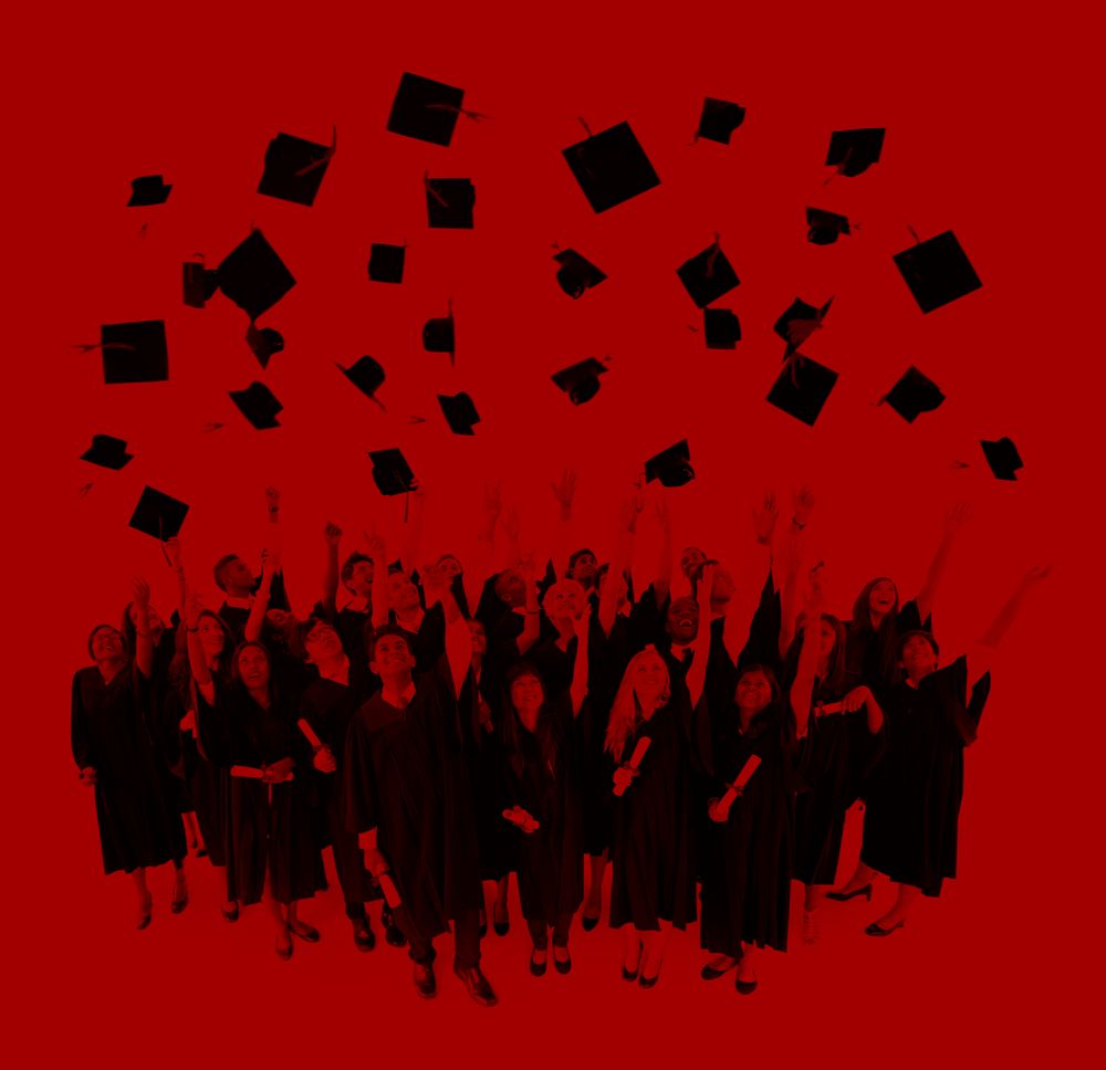 Graduating students throwing hats in the air