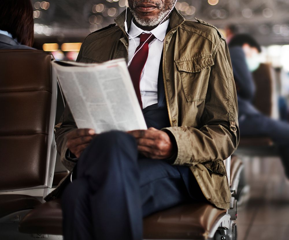 African descent businessman is using earphones
