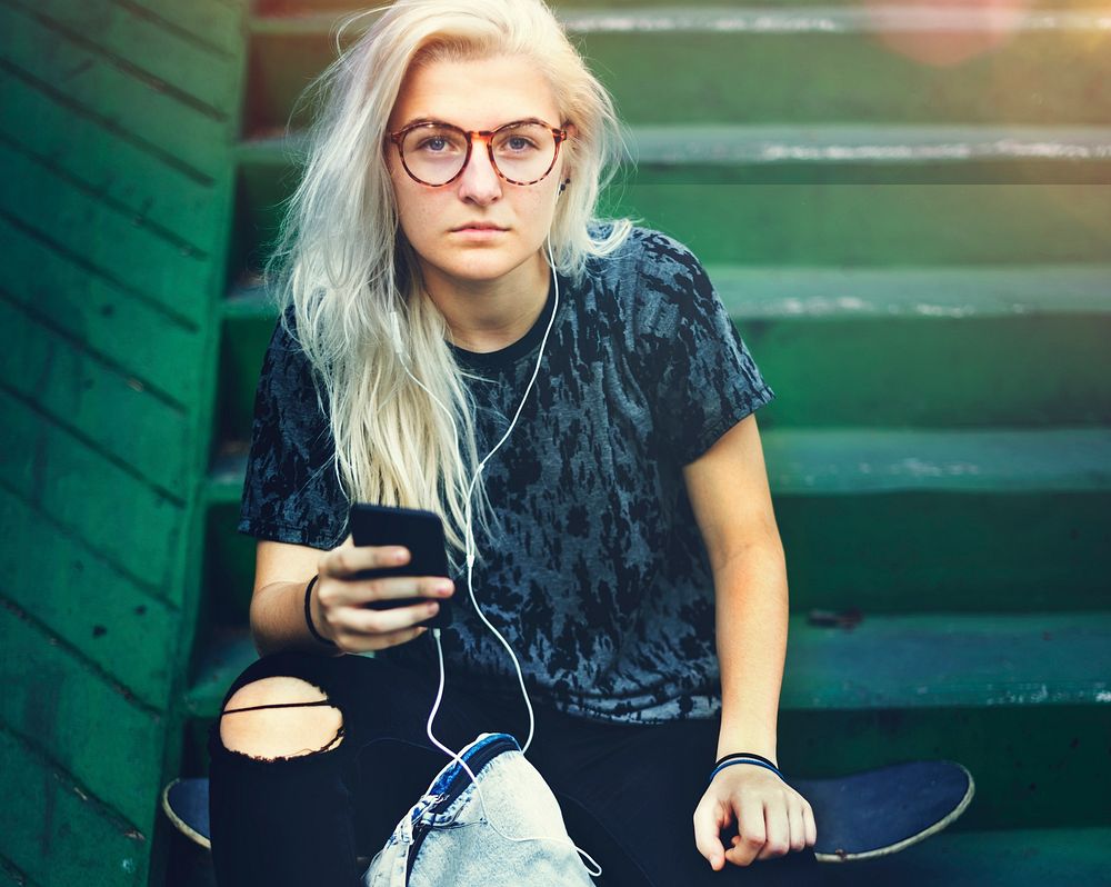 Skateboard Girl Listening Music Concept
