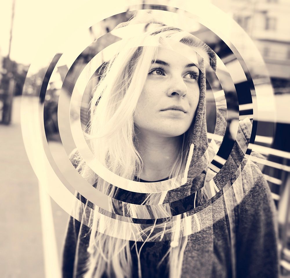 Young hipster woman listening music standing on the street