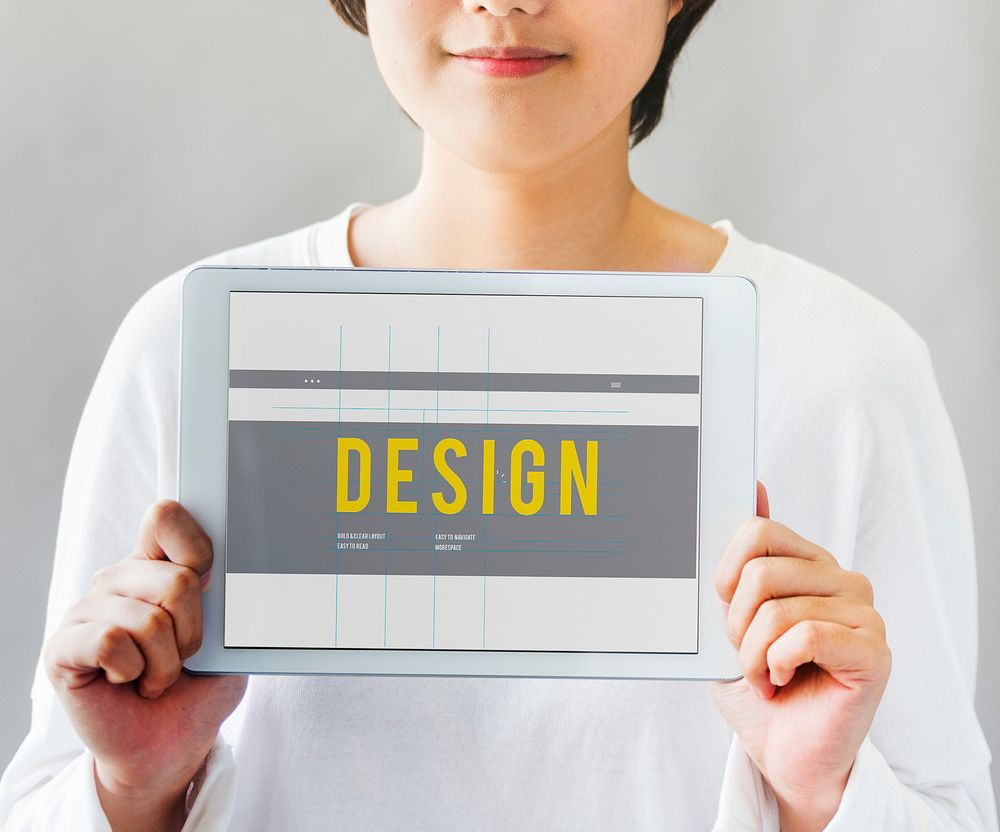 Closeup of asian woman holding digital tablet with design word showing on screen