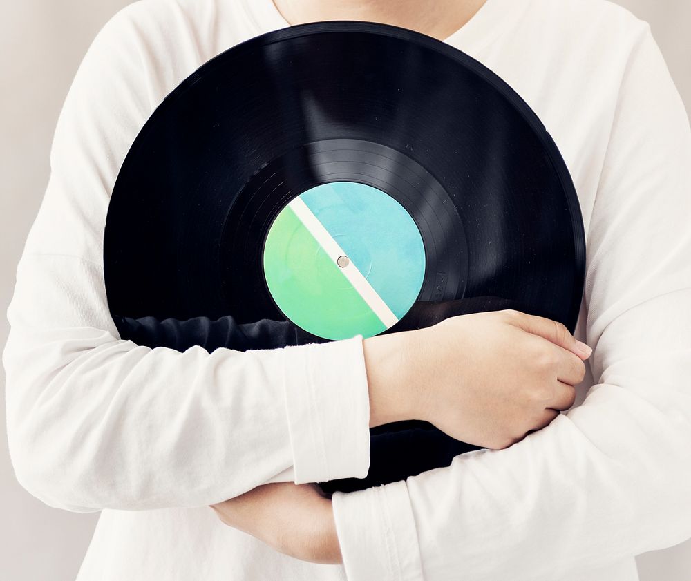 Closeup of woman holding music vinyl record disc