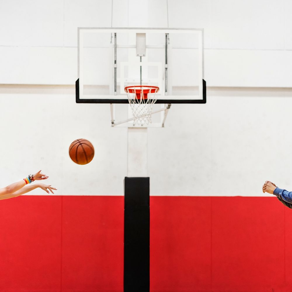 Hands shooting basketball to the net hoop