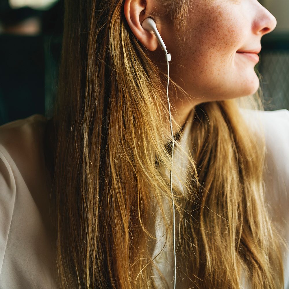 Young caucasian woman is listening to music