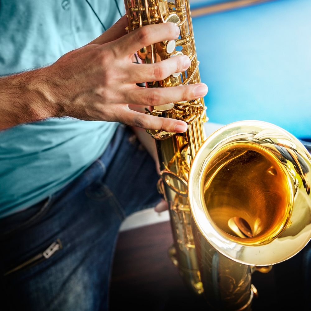 Closeup of hands playing saxophone