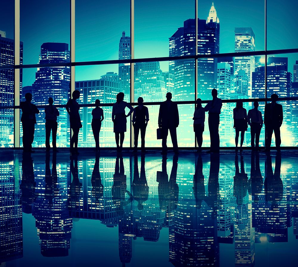 Silhouettes of business people standing in an office building.