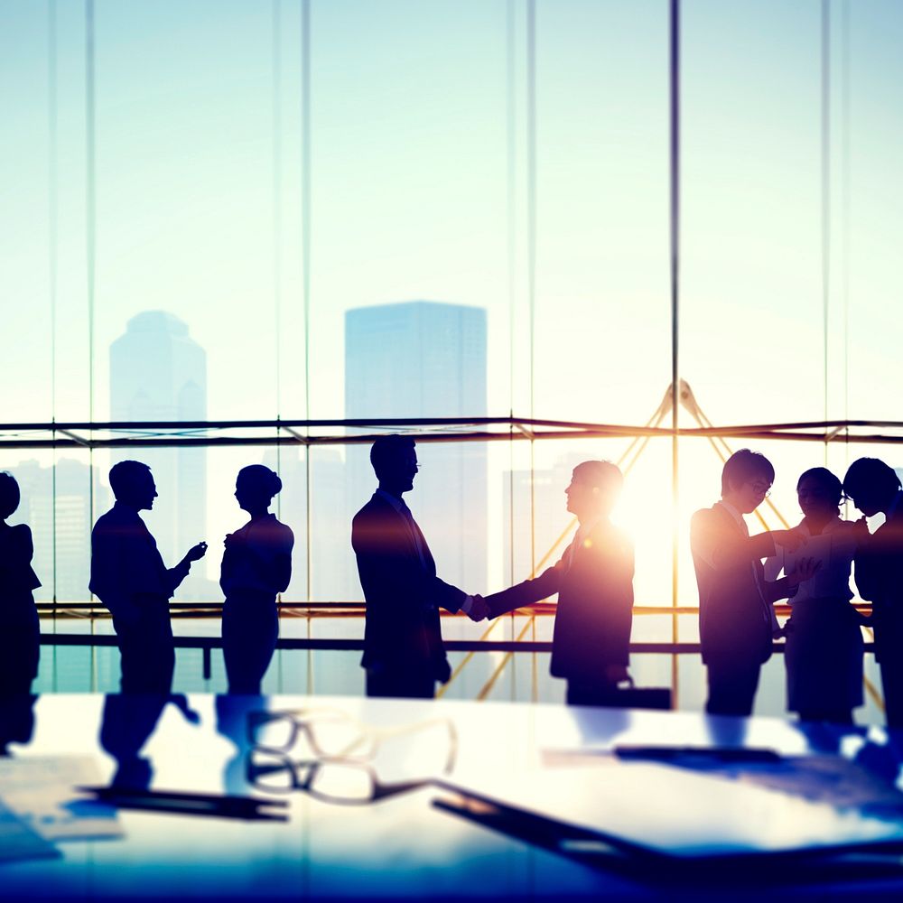 Silhouettes of Business People Meeting Handshake Concept