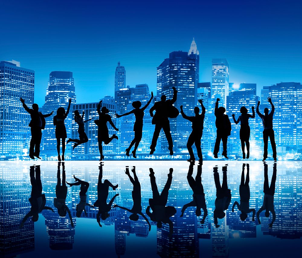 Group Of Happy Business People Silhouettes Jumping For Celebration On Cityscape Background