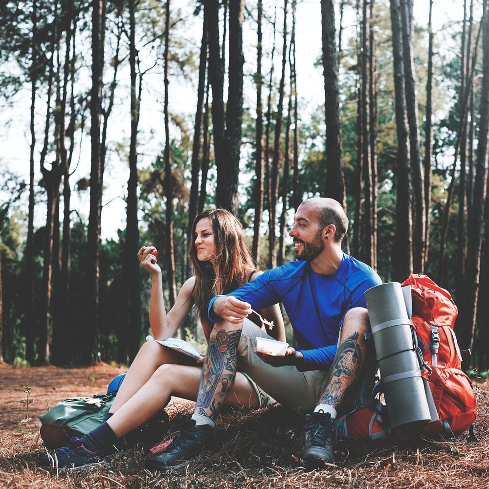 Traveler couple taking a break in the forest