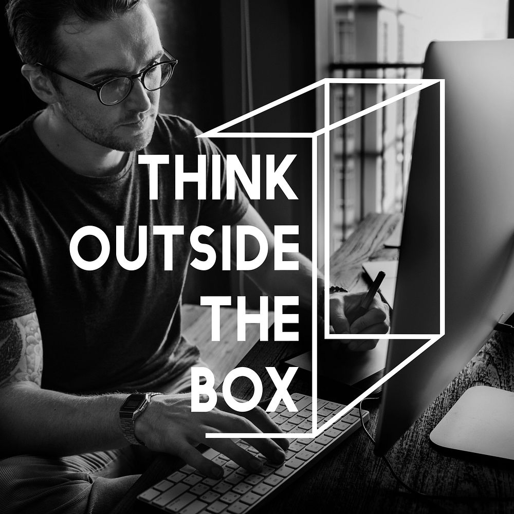 Think outside the box phrase on man working on computer background