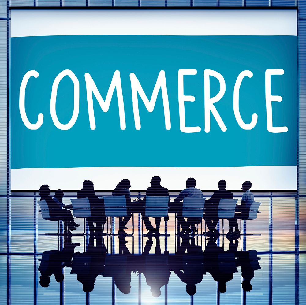 Commerce text with silhouette of business people at a meeting table