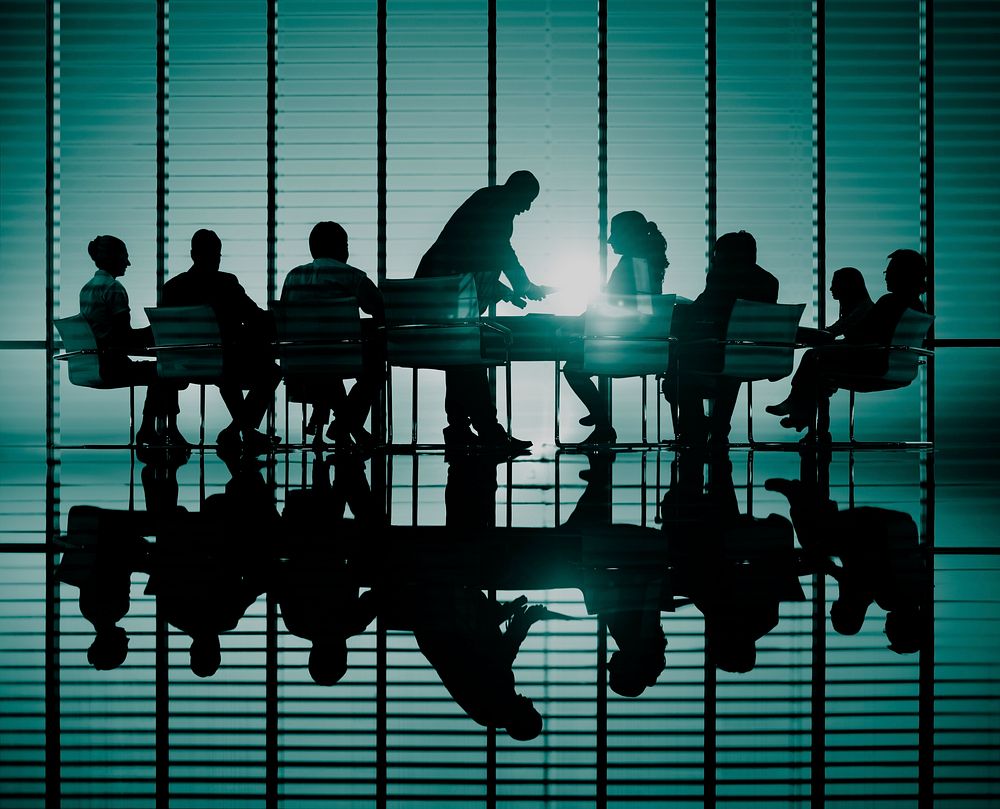 Silhouettes of business people in a conference room Concept