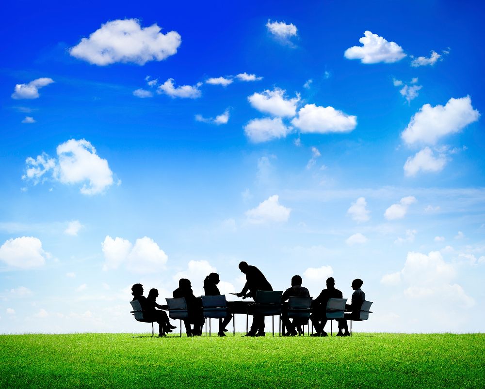 Business People Discussing Around The Conference Table Outdoors In A Scenic View