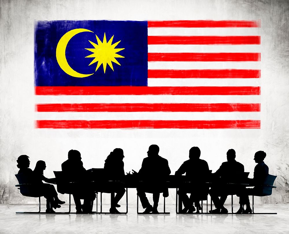 Silhouettes of Business People and a Flag of Malaysia