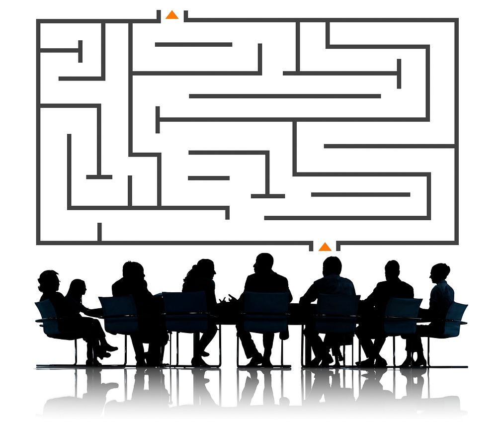 Illustration of a maze with silhouette of business people at a meeting table