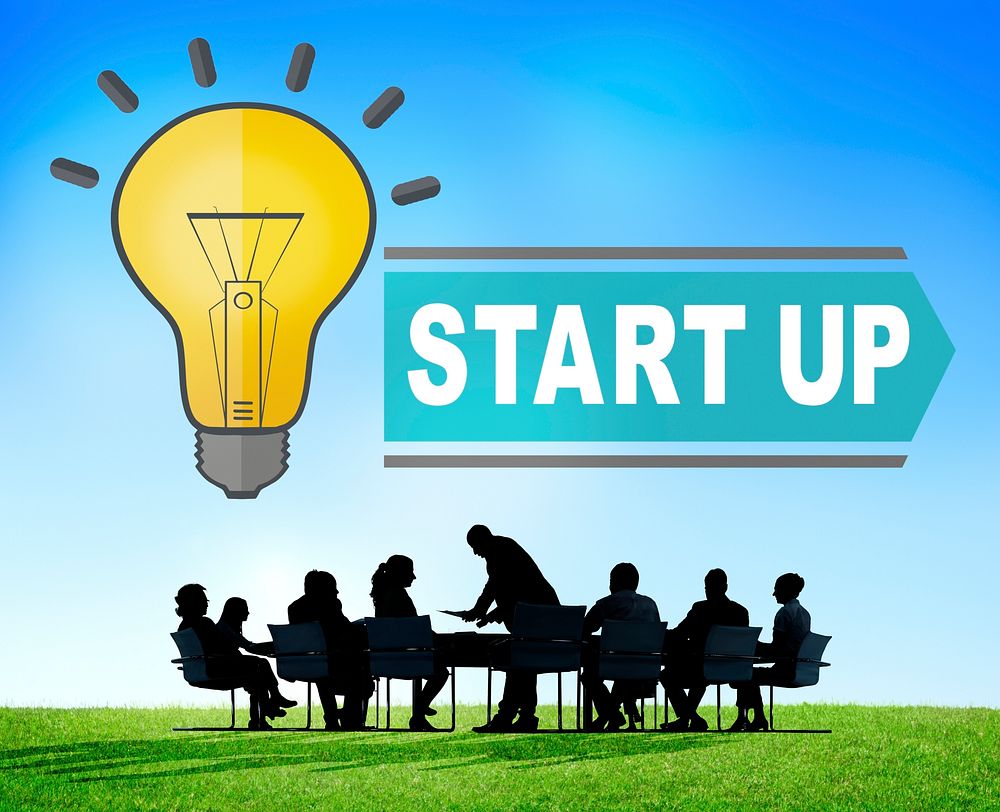 Startup light bulb illustration with silhouette of business people at a meeting table