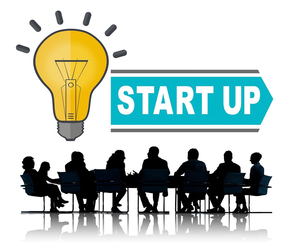 Start up light bulb illustration with silhouette of business people at a meeting table