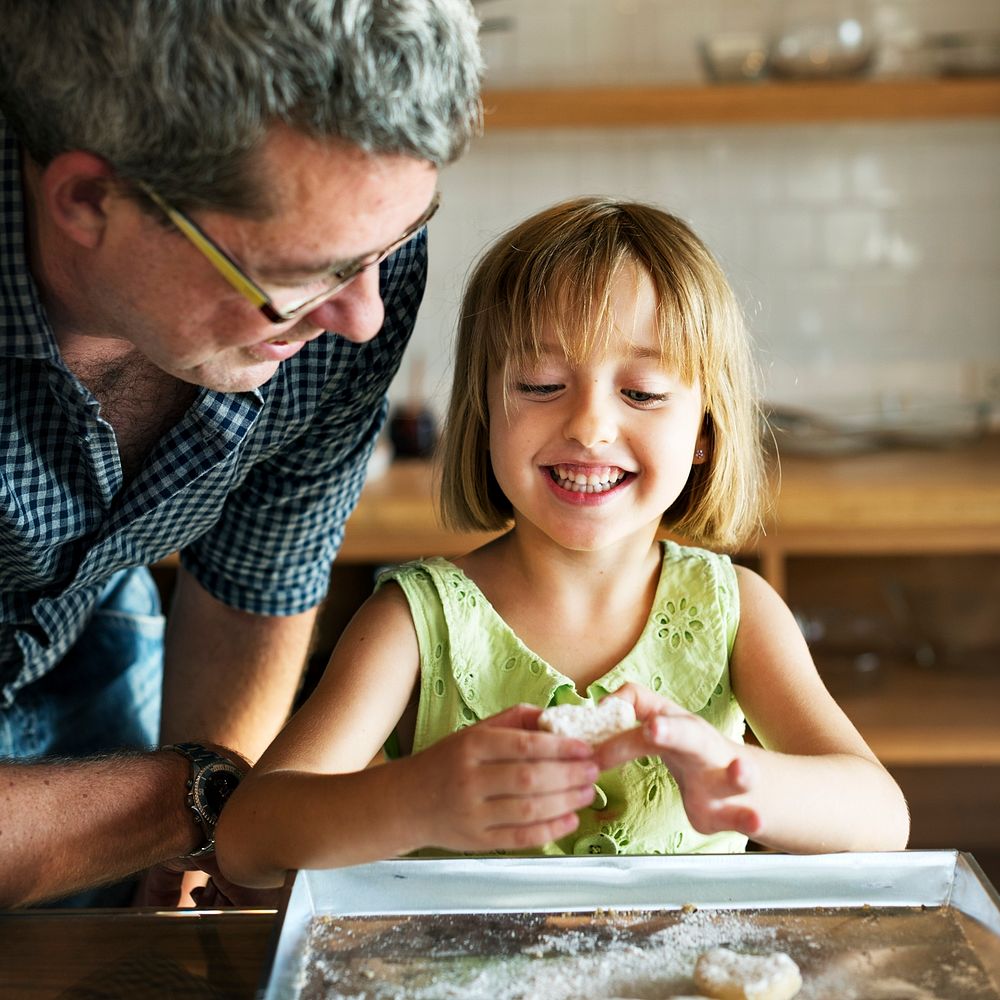 Little girl baking with her father