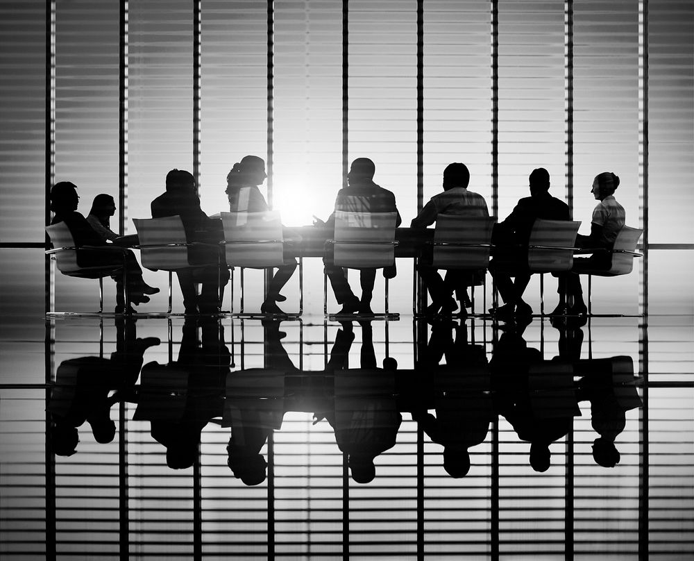 Silhouettes of business people in a conference room.