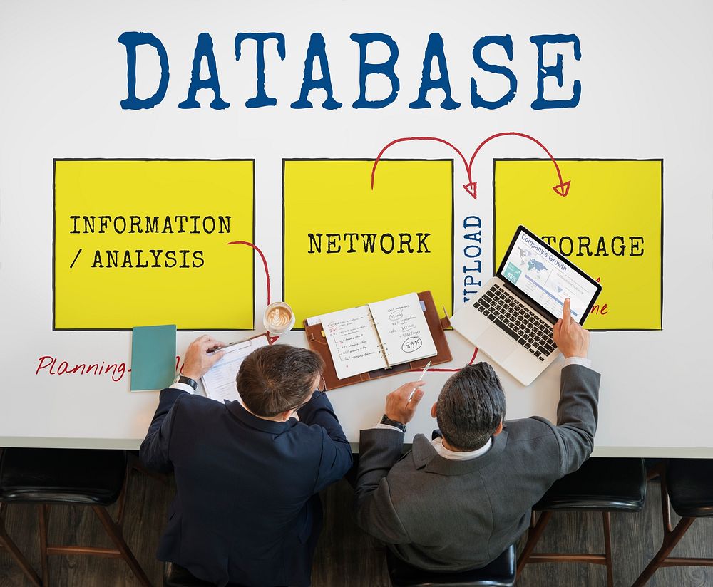 Database diagram on the table with two businessmen