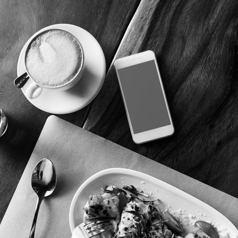 Aerial view of mobile phone and food on the table